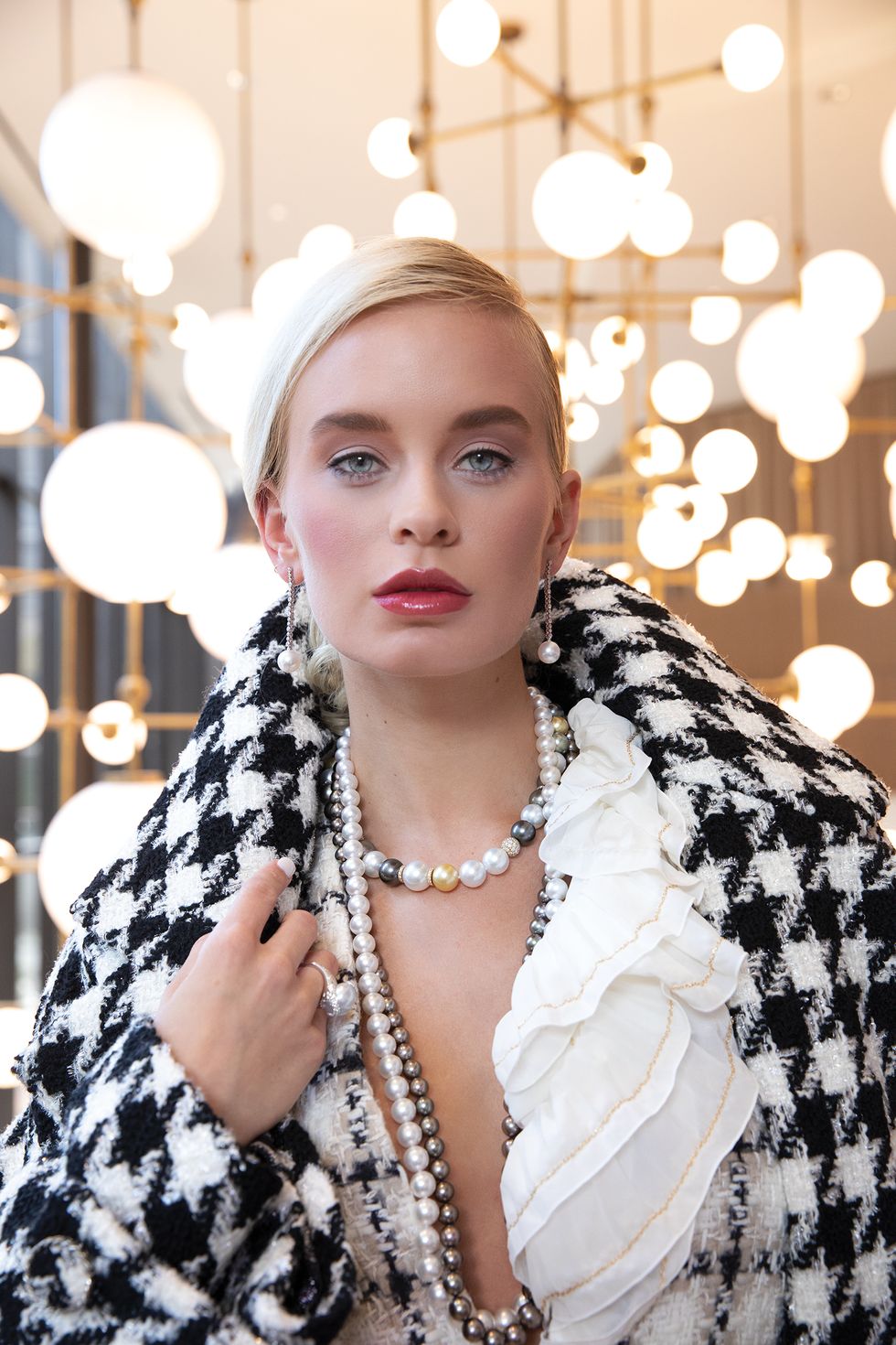 Crepe scarf, $2,350, tweed jacket, $5,400, and coat, $9,200, all by Chanel; pearl earrings, $18,000, ring, $9,800, and necklaces, from $16,500, all by Mikimoto at Zadok Jewelers.