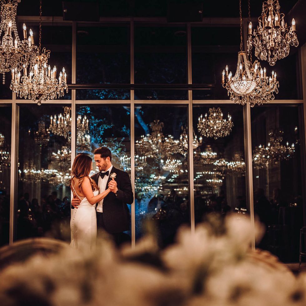 The newly minted Almquists savor a romantic and intimate “last dance” amid the chandeliers at the end of their reception.