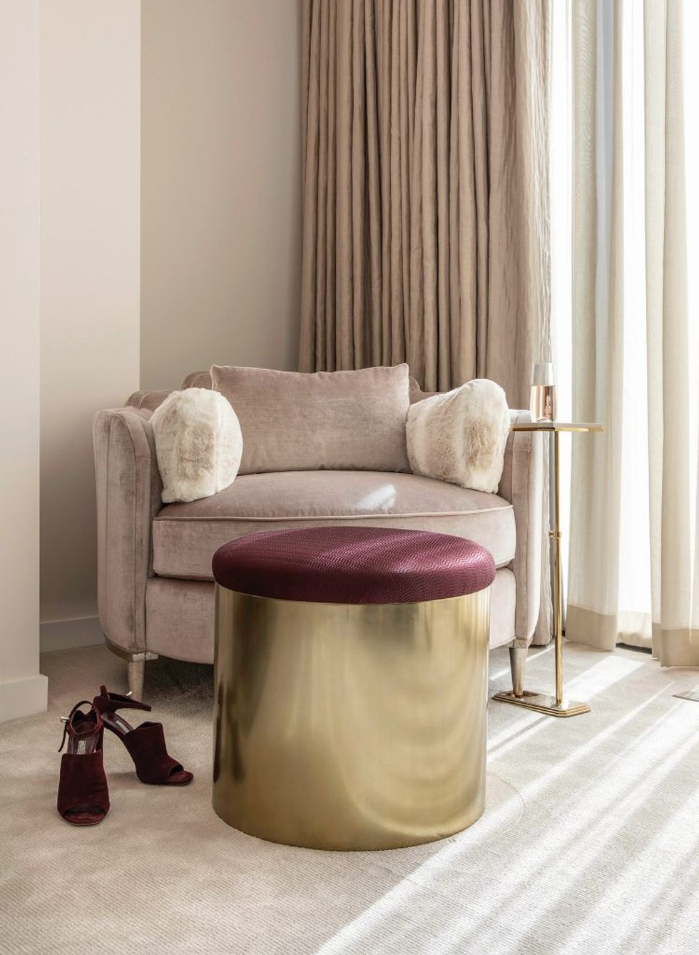 Designer Laura Umansky’s favorite touch — a rounded chair by Caracole near the window.