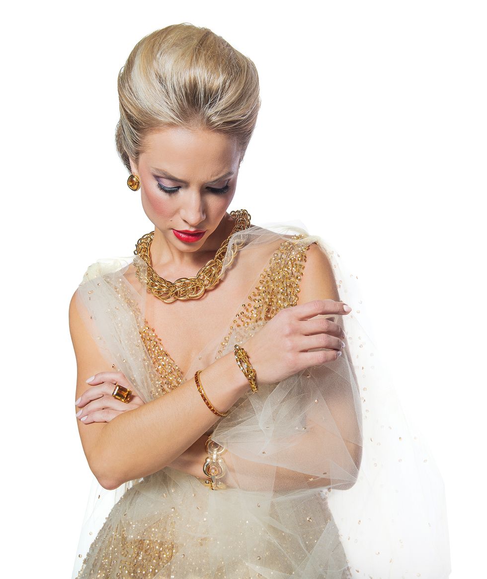 Gown, by Oscar de la Renta; earrings, $5,890, giraffe bracelet, $7,480, citrine ring, $7,900, citrine bracelet, $5,650, 1940s bracelet, $11,800, and necklace, $46,800, all at Tenenbaum Jewelers.