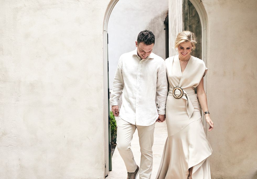 Bregman wears a shirt and shoes by Ermenegildo Zegna and pants by Isaia, all from M Penner. Howard wears a Silvia Tcherassi dress and Fendi shoes, both from Tootsies, with jewelry from Deutsch Houston.