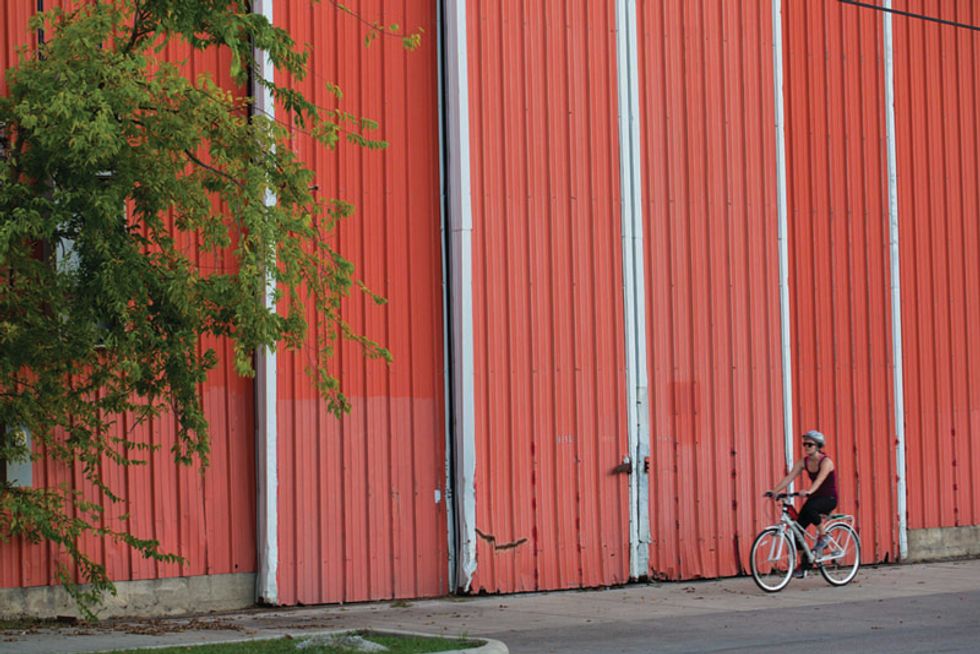 Cyclist enjoys a spin passed one of EaDo’s many signature warehouses