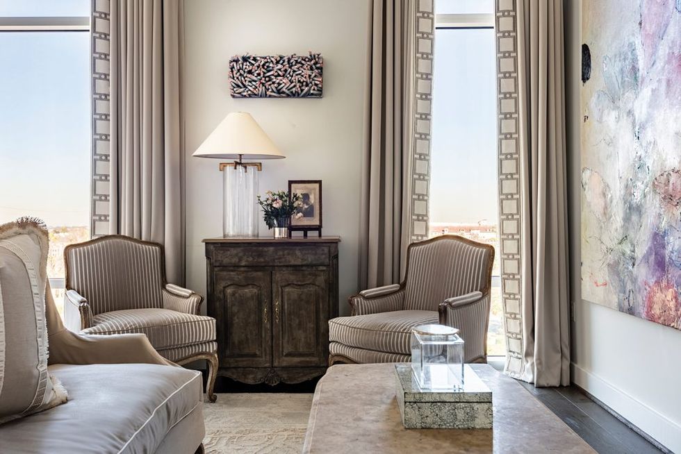 A sitting area in the master bedroom touts the wood-and-paint “Bending the Lines #2” by Gil Bruvel and a large-scale painting by Allison Stewart.