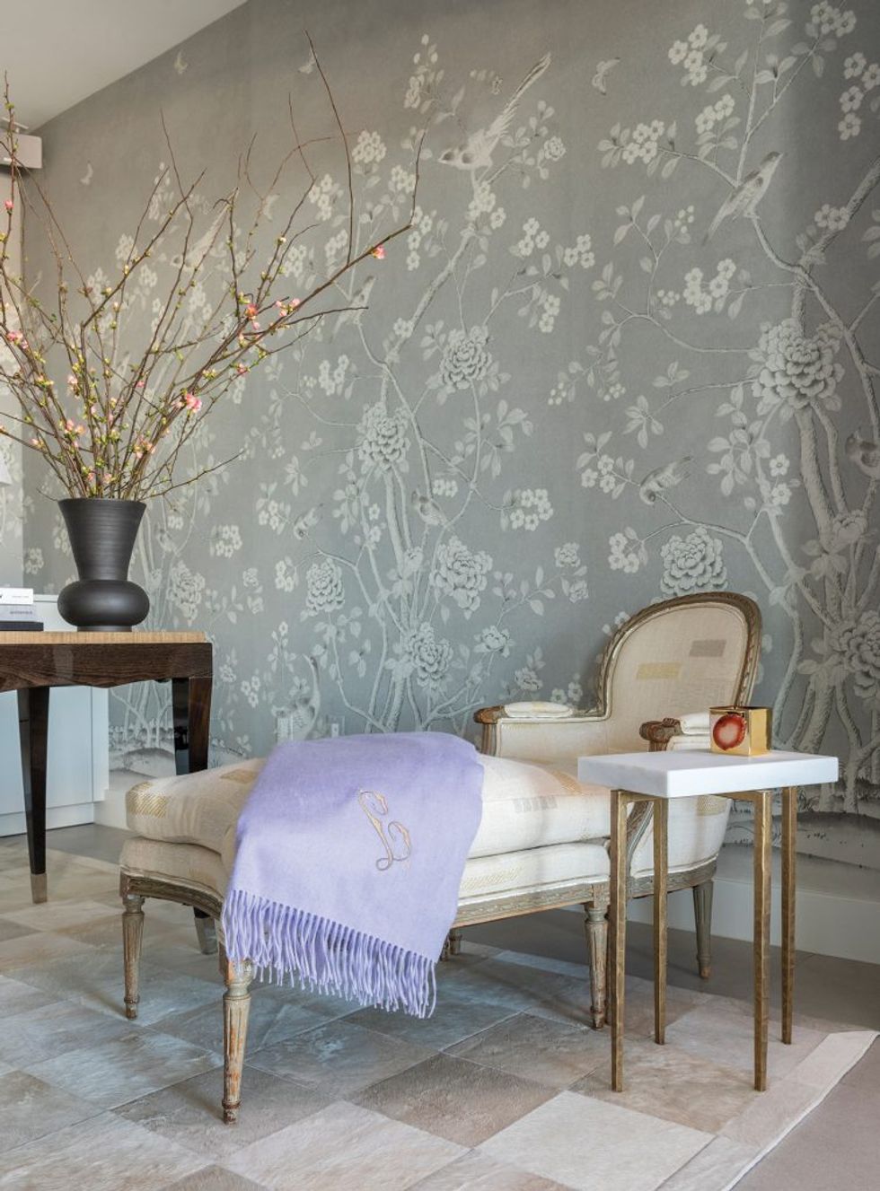 Rathe’s study features Schumacher wallcoverings and a French chair and ottoman in creamy Dedar fabric 