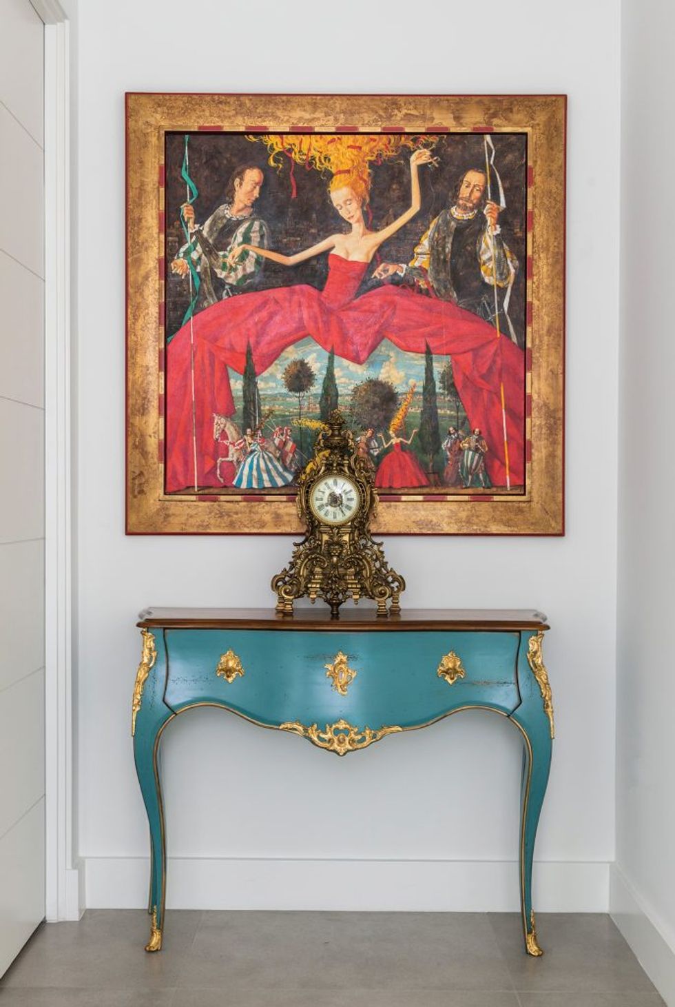 An oil painting by Roman Zaslonov hangs over an antique console