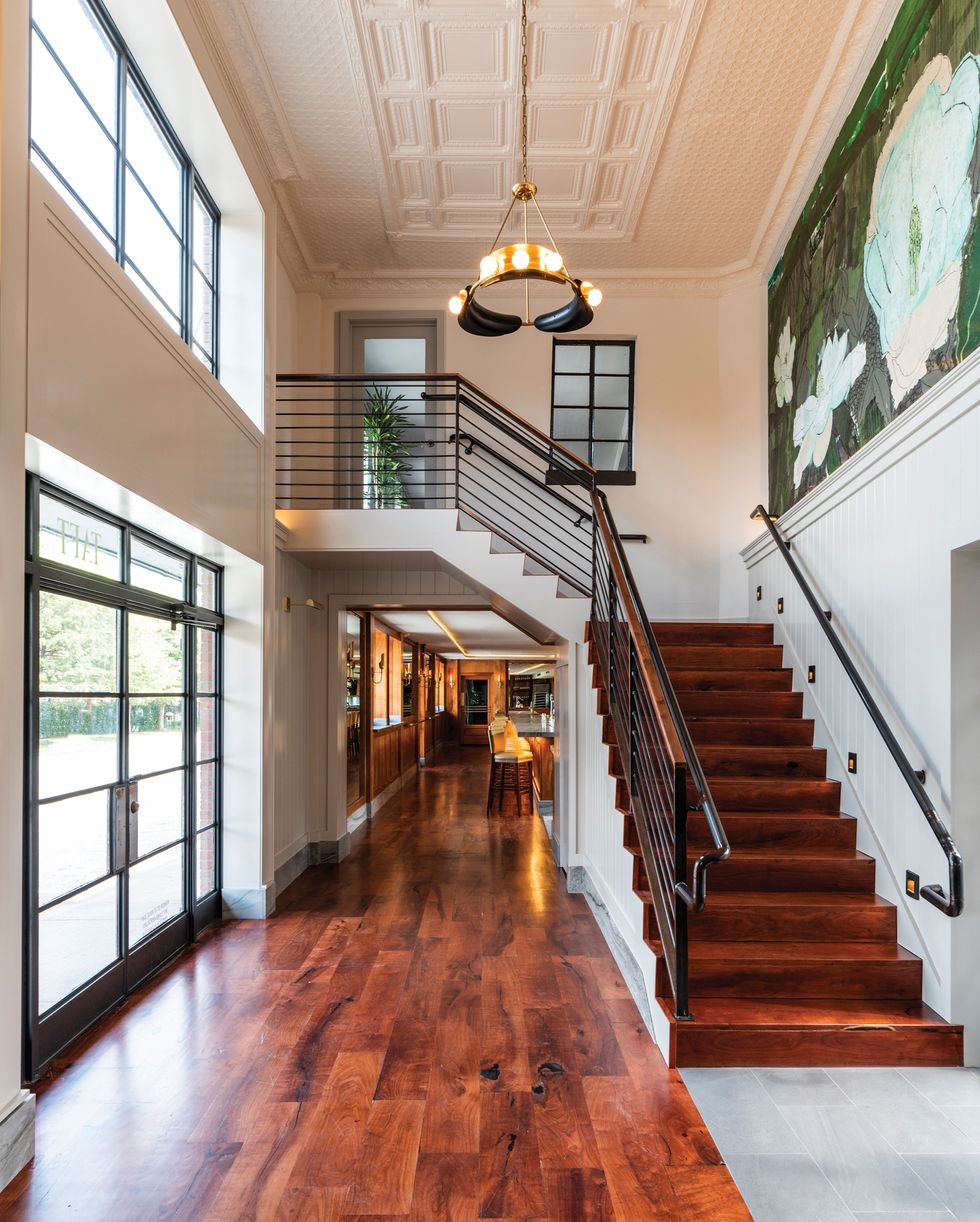 Bludorn’s entryway features a mural of magnolias and a stairway leading to a private dining room upstairs